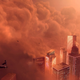 A helicopter tries to outrun a dust storm approaching a city at sunset in Battlefield 2042.